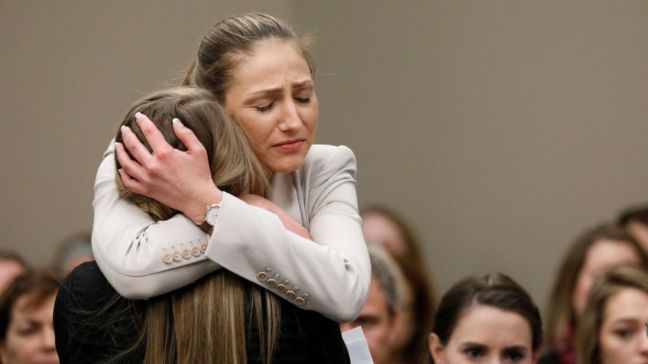 Emily Morales hugged after testifying.